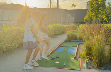 Wall Mural - teenage girls play mini golf