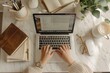 © оLeo Studio - Freelancer Working on Laptop in Cozy Home Office, Coffee and Notebook on Desk, Overhead View. Hands with laptop Top view. Aesthetic lifestyle photo