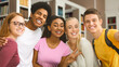 © Prostock-studio - Group selfie of friends. Happy international college students smiling at library