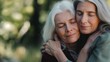 © nopommajun - Two elderly women in a close, affectionate embrace, highlighting the deep bond and love between them with a soft-focus background