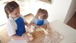© maxximmm - children making dough in the kitchen. two little girls cook in the kitchen knead dough and flour indoors. happy family kid dream concept. children play cooking dough together at home lifestyle