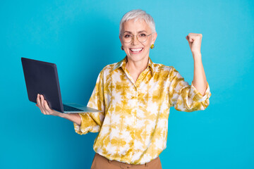 Sticker - Photo portrait of pretty retired female hold netbook winning wear trendy elegant outfit isolated on blue color background