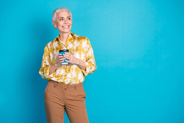 Sticker - Photo of lovely pensioner lady hold coffee paper cup look empty space dressed stylish elegant garment isolated on blue color background