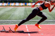© skumer - Female sprinter launches from the starting blocks with explosive power
