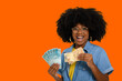 © Edson Souza - happy woman holding money, brazilian money