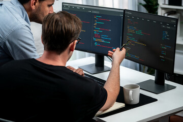 it developers discussing online software development information on pc screen, creating program codi