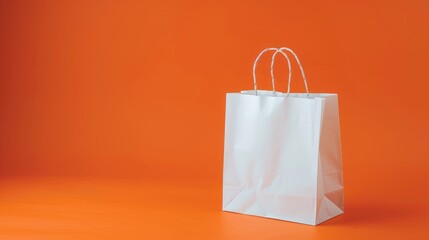 Wall Mural - Side view of white shopping bag on orange paper background