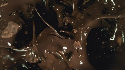 Poster - Super Slow Motion of Falling Group of Chocolate Chunks. Moving Down and Splashing into Melted Chocolate. Filmed on High Speed Cinema Camera, 1000fps.