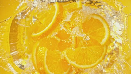 Aufkleber - Super Slow Motion of Falling Orange Slices into Water, Colored Background. Filmed on High Speed Cinema Camera, 1000 fps. Camera Tracking the Target.