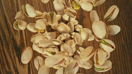 Poster - Super Slow Motion of Flying Pistachio Nuts over Wooden Planks. Camera Tracking the Target. Filmed on High Speed Cinema Camera, 1000fps.