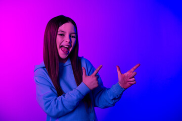 Sticker - Photo of excited attractive little lady dressed hoodie showing two fingers empty space isolated neon pink color background