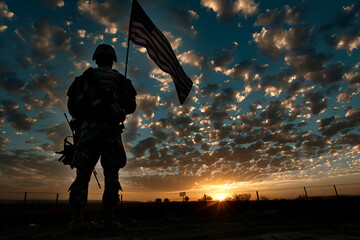 A soldier holding an American flag at sunset