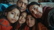© iuricazac - A warm family moment captured in a selfie with a man a woman and three young girls sharing a close embrace their faces lit up with smiles creating a heartwarming scene of togetherness and love.