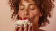 © iuricazac - A woman with curly hair eyes closed enjoying a bite of a cake with white frosting and red berries.