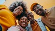 © iuricazac - Four friends posing for a selfie smiling broadly with vibrant yellow background showcasing joy and camaraderie.