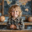 © 3AI studio - A young child with curly blonde hair, smiling and sitting at a wooden desk. The background features a map and globes, indicating a classroom setting.
