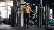 © Prostock-studio - Best cardio workout. Sporty muscular man with perfect body training with skipping rope in gym interior, free space