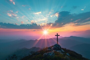 Silhouettes of crucifix symbol on top mountain with bright sunbeam on the colorful sky background