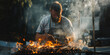 © Mr. Stocker - Bearded man grilling meat over flames on a summer day