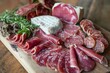 © StockUp - Artful arrangement of high-quality charcuterie with herbs on a rustic wooden surface