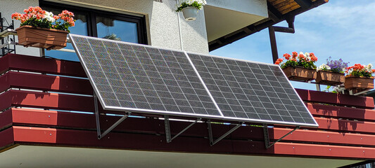 balcony solar system, fixed at an angle of 30 degrees on the red balcony of an apartment building, s