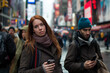 © Melipo-Art - Young woman and man using smartphones in a busy city street