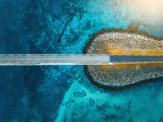 Wall Mural - aerial view of road, sea, stones at sunset in lofoten islands, norway. landscape with beautiful brid