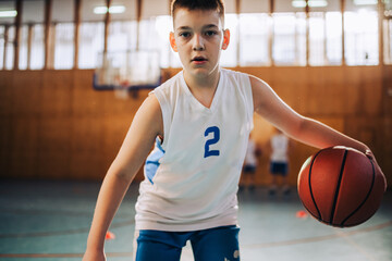 Wall Mural - Young basketball player focused on the game