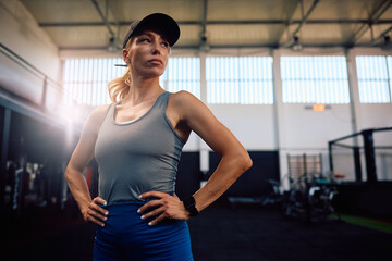 portrait of confident athletic woman in gym looking away.