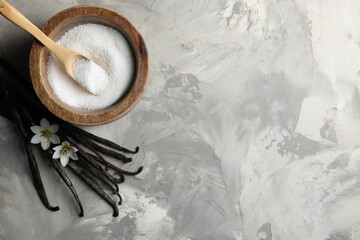 Wall Mural - Sugar in bowl, vanilla pods and flowers on grey textured table, flat lay. Space for text