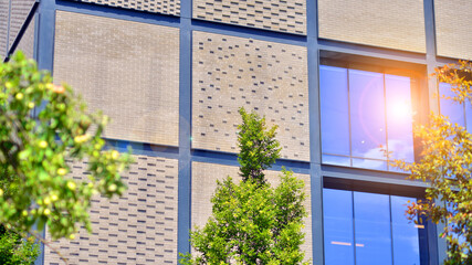 Wall Mural - Exterior of a modern industrial building with green environment. Corporate building reduce CO2. Eco building.