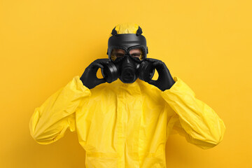 Wall Mural - Worker in gas mask on yellow background