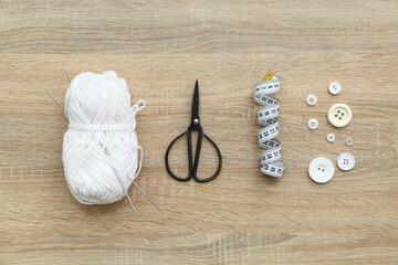 Sticker - Yarn ball, scissors and knitting accessories on wooden background