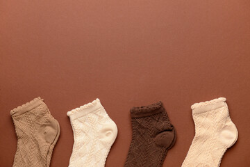 Canvas Print - Different basic color socks on brown background