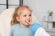 © Pixel-Shot - Pediatrician examining little girl with tongue depressor in clinic