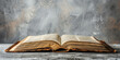 © Keitma - Open holy book on grey surface and copy space banner background