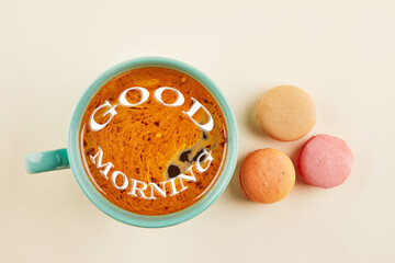 Wall Mural - Multi-colored macaroons of different colors and flavors on a beige background with a cup of coffee. View from above