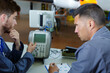 © auremar - aviation assembling apprentice pointing at complex machine
