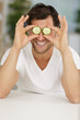 © auremar - young man covering his eyes with cucumber slices