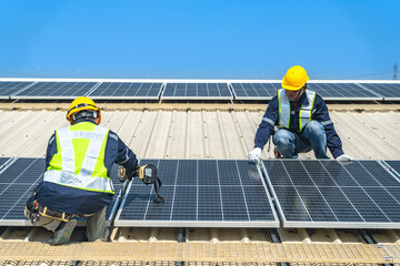 Wall Mural - worker technicians are working to construct solar panels system on roof with sky and clound on backg