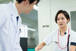 © amanaimages - カルテを見る医師と看護師