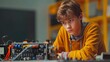 © MaiHuong Studio - A young boy building a robot for a school project on a silver background banner for copy space