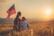 © MobiWall - Patriotic holiday. Happy family, mother and daughter with American flag outdoors on sunset. USA celebrate independence day 4th of July