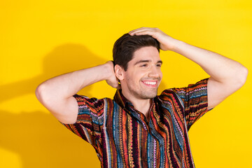 Canvas Print - Photo of nice young man hands touch hair wear shirt isolated on yellow color background