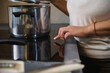 © Taras Grebinets - Cooking on induction stove with stainless steel pot