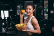 © Quality Stock Arts - Healthy women in Fitness Gym Body Care by Eating Mix Fruits and weight Training in Sport Club.