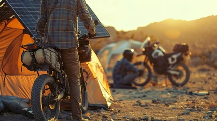 Wall Mural - An adventurous group of friends camping in the desert utilizing their tents solar panels to charge their electric bikes for an offroading adventure.