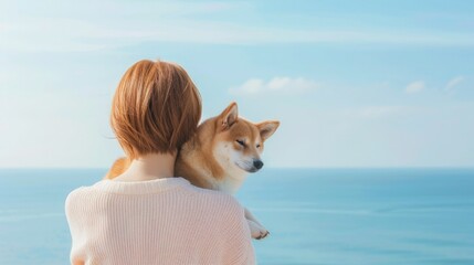 Wall Mural - Coastal Companionship: A Shiba Inu and Woman Gaze at the Ocean