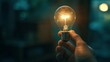 © MP-AI - Close-up of a hand holding a glowing light bulb with a dark blurred background, symbolizing creativity, innovation, and bright ideas.
