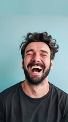 Poster - A bearded man wearing a black shirt laughs with his eyes closed